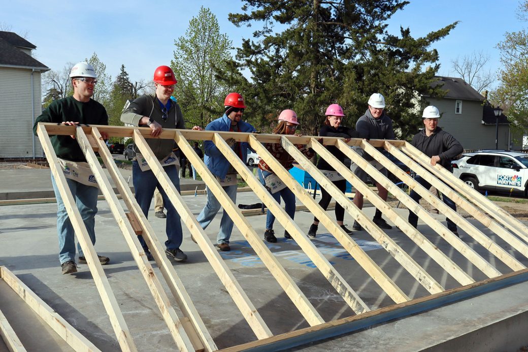 Volunteers raising wall at kickoff