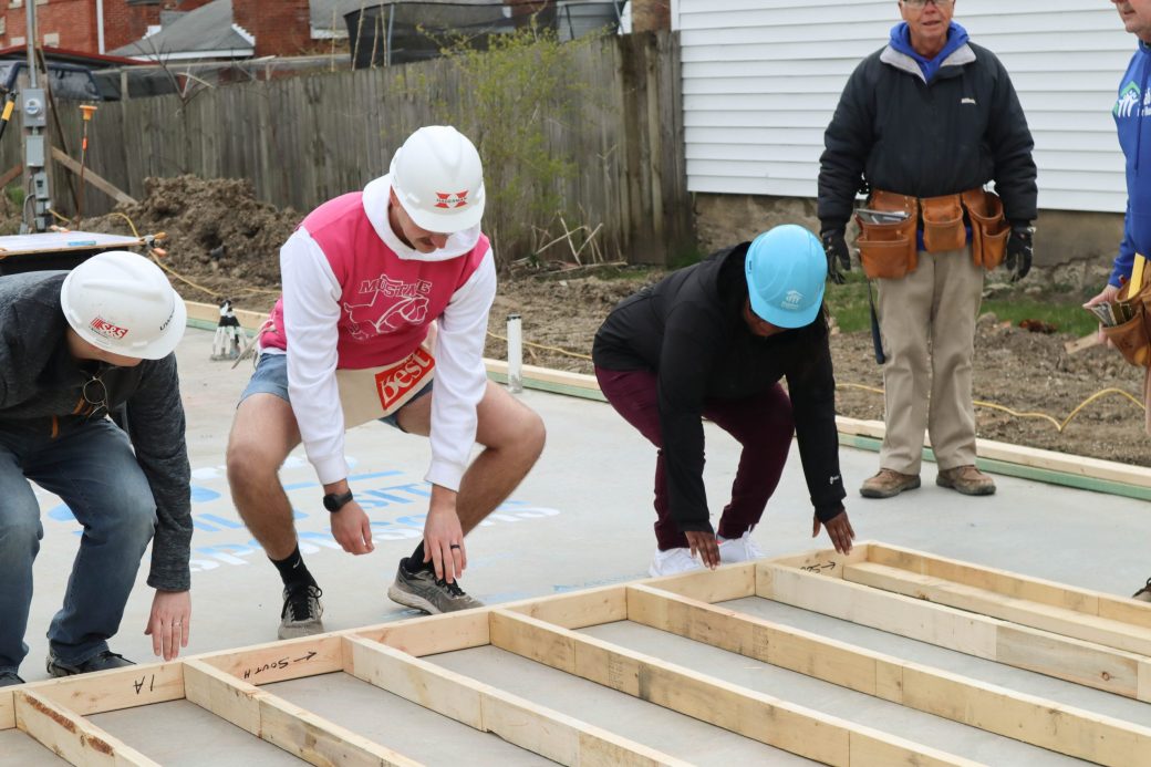 Volunteers raising first wall