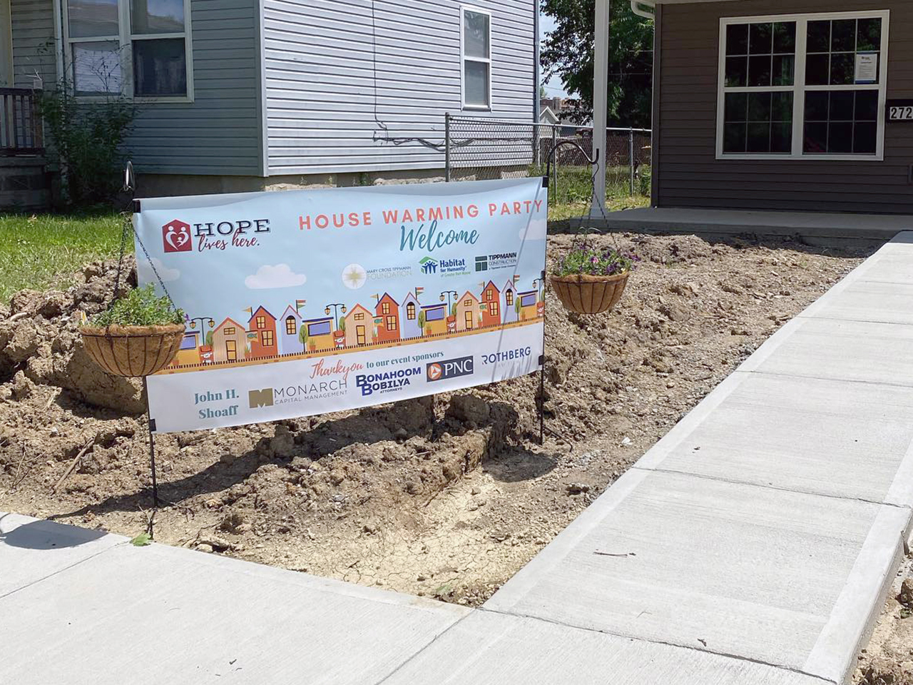 Banner at Vincent Village housewarming with sponsors