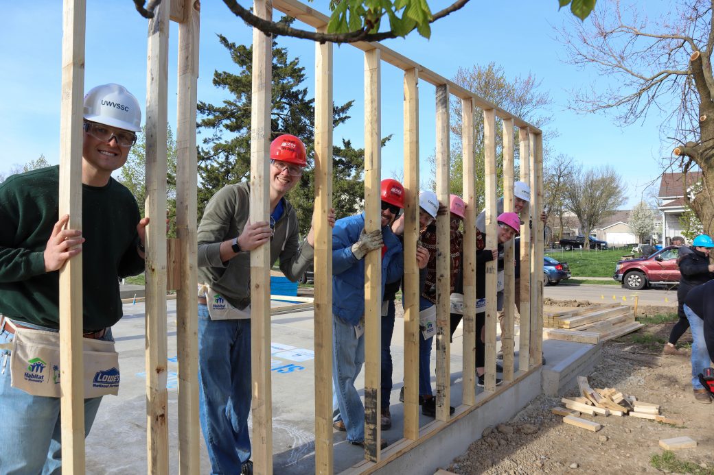 Volunteers behind wall they built