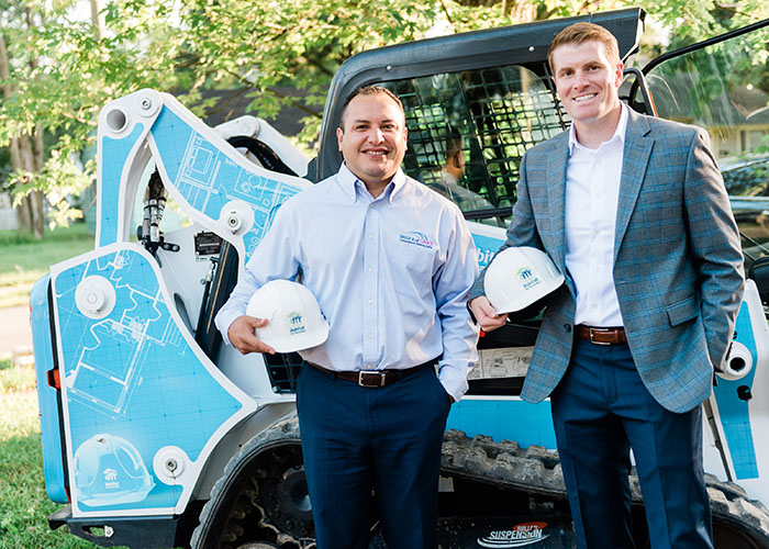 Two men with hard hats