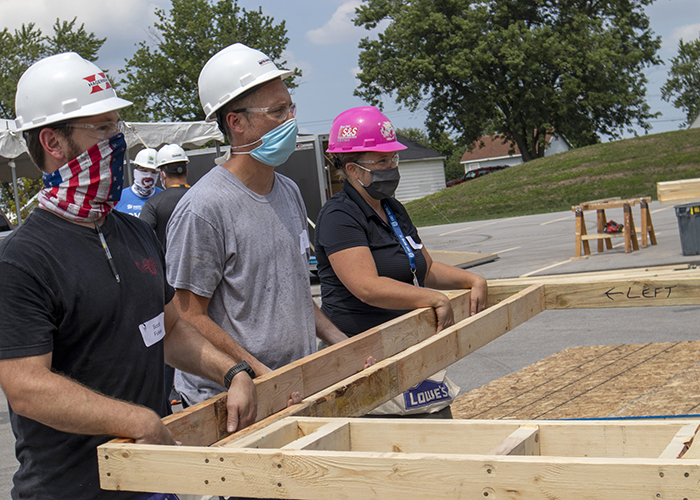 Volunteers carrying wall