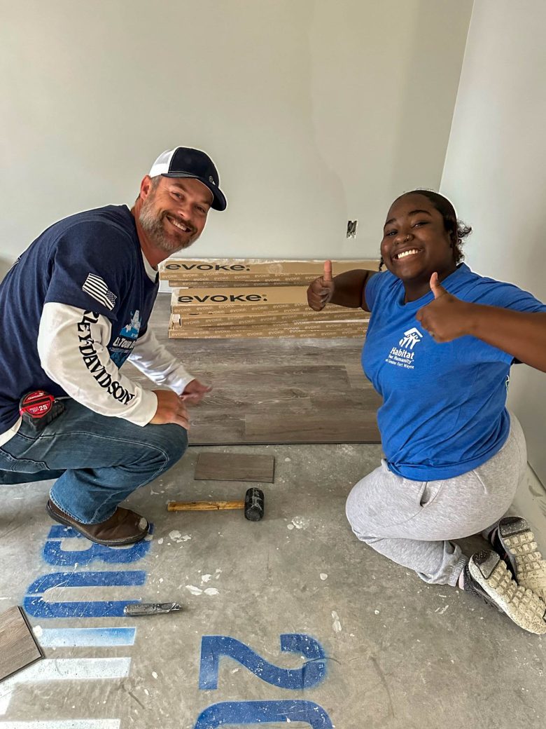 Student installing flooring