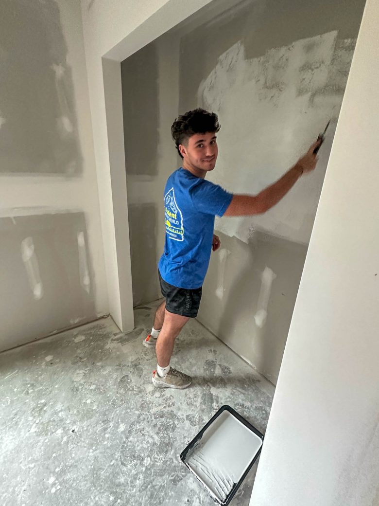 Male student painting with brush