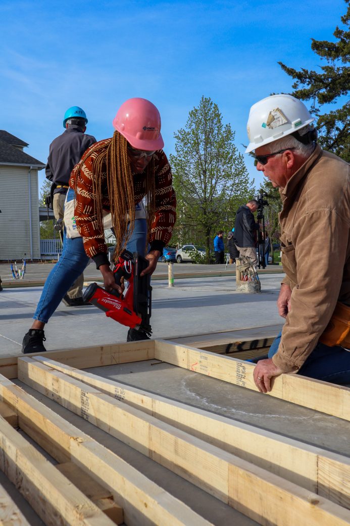 Crew lead assisting Partner Family with nail gun