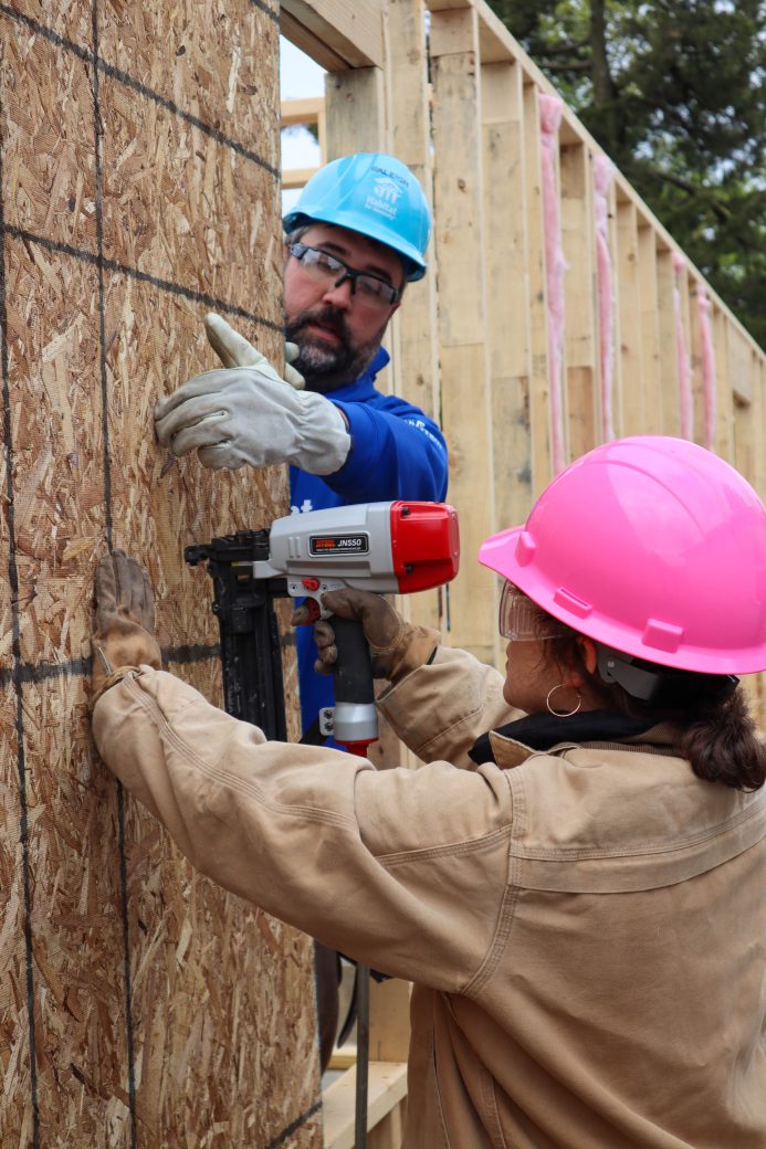 Habitat staff helping volunteer