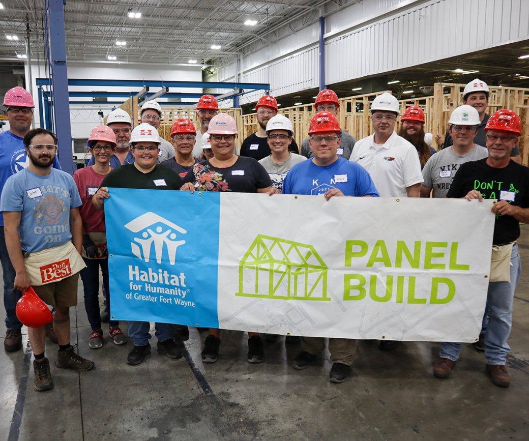 Volunteers with "Panel Build" sign