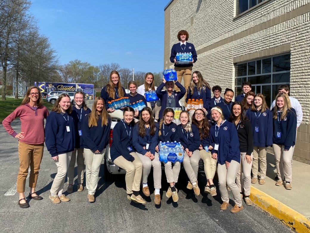 Group of students with water bottle donations
