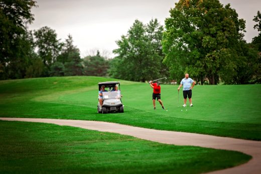 Golf players hitting ball