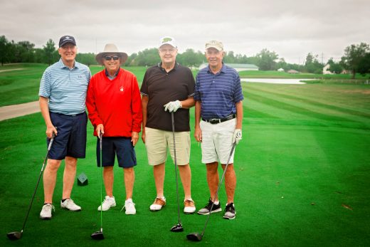 four men on a golf course