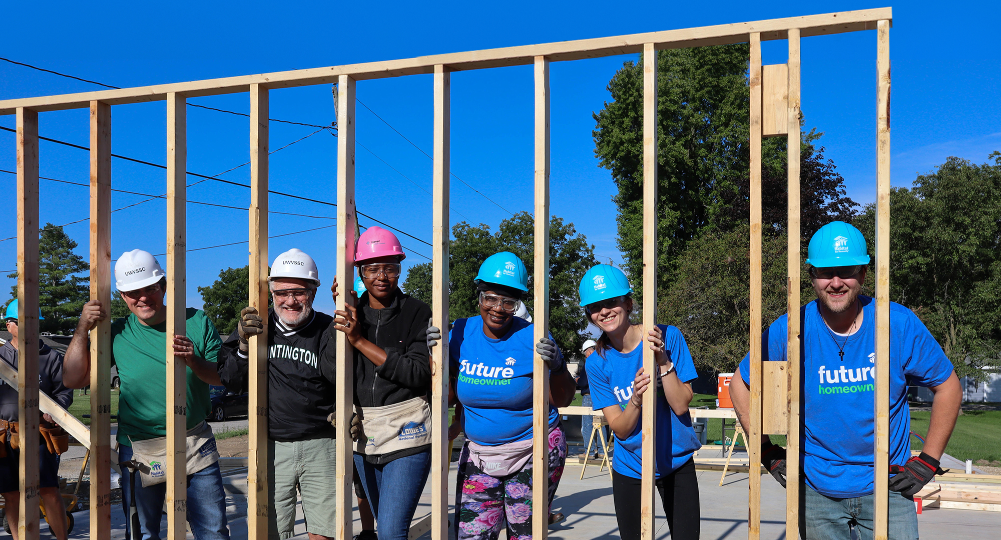 Huntington volunteers holding up built wall