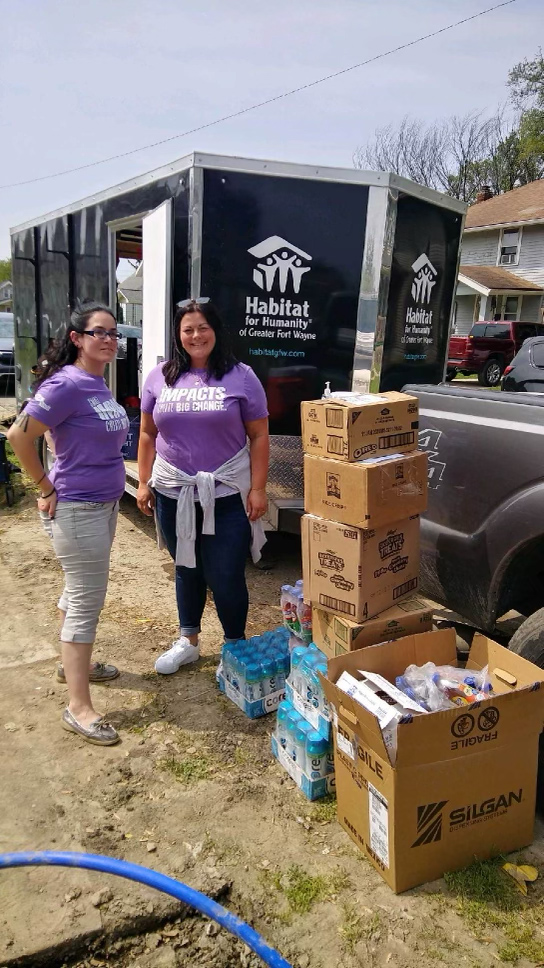 Volunteers next to donated boxes of snacks