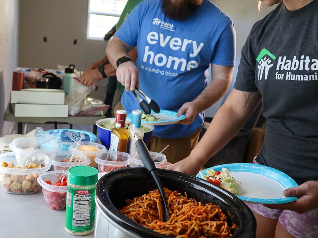 Volunteers filling plates with food