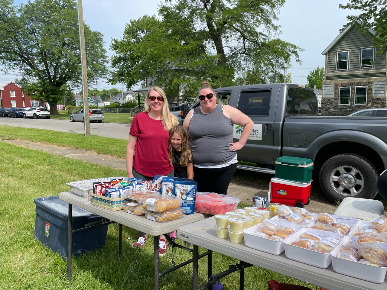 Two women with lunch donation of sandwiches