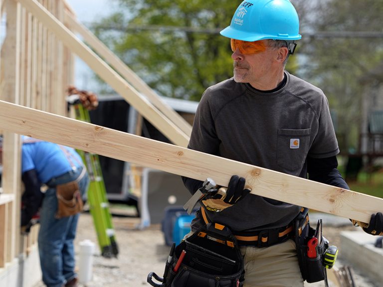 Construction manager lifting wood support