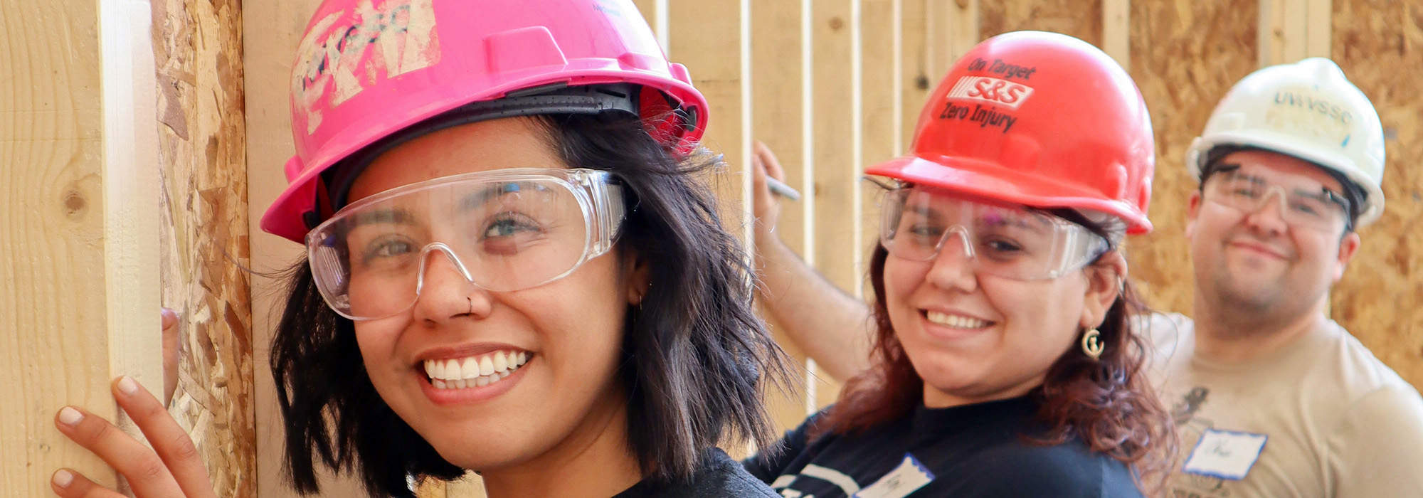 Three volunteers smiling