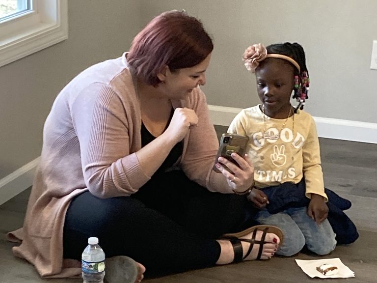 Lauren showing Partner Family child her phone