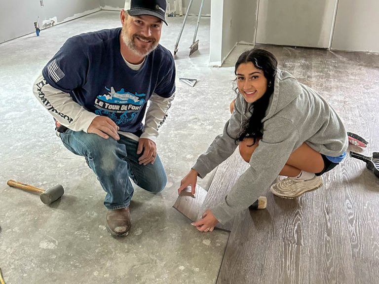 Volunteers laying flooring