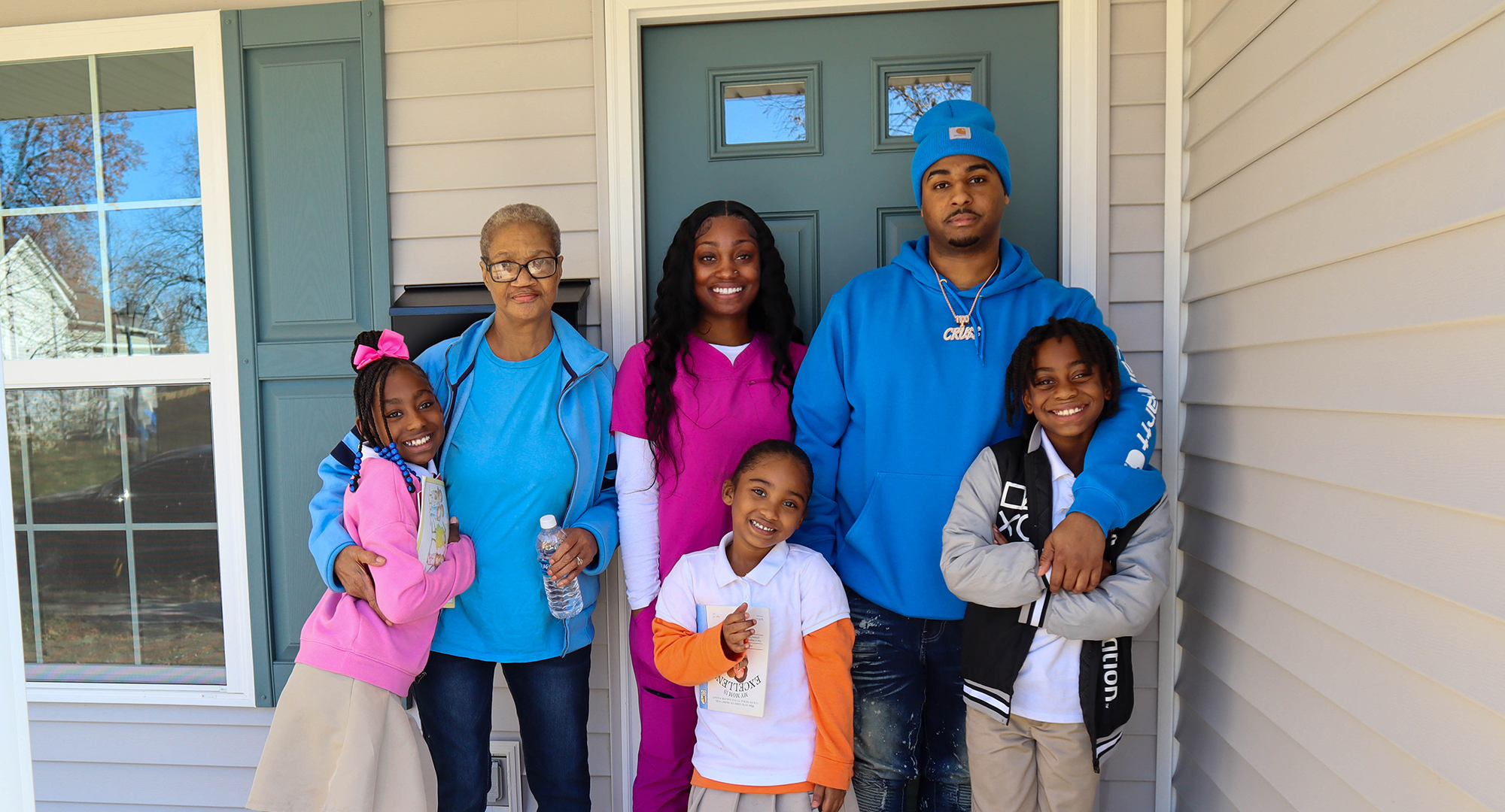 Tiyonna and family in front of house