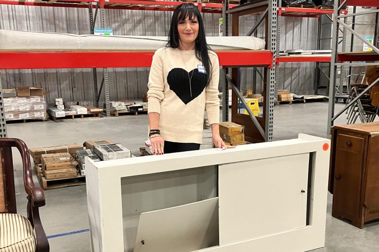 Audrey Harber with wooden cabinet